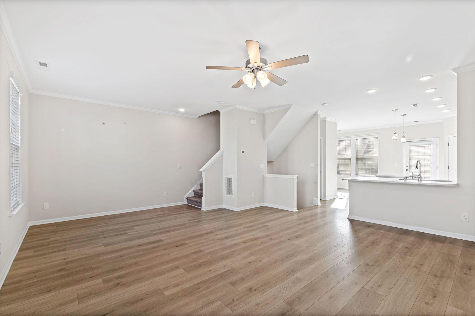 6103 Kayton Street Raleigh, NC 27616 - Photo 7 of 45 a view of an empty room with wooden floor and a window