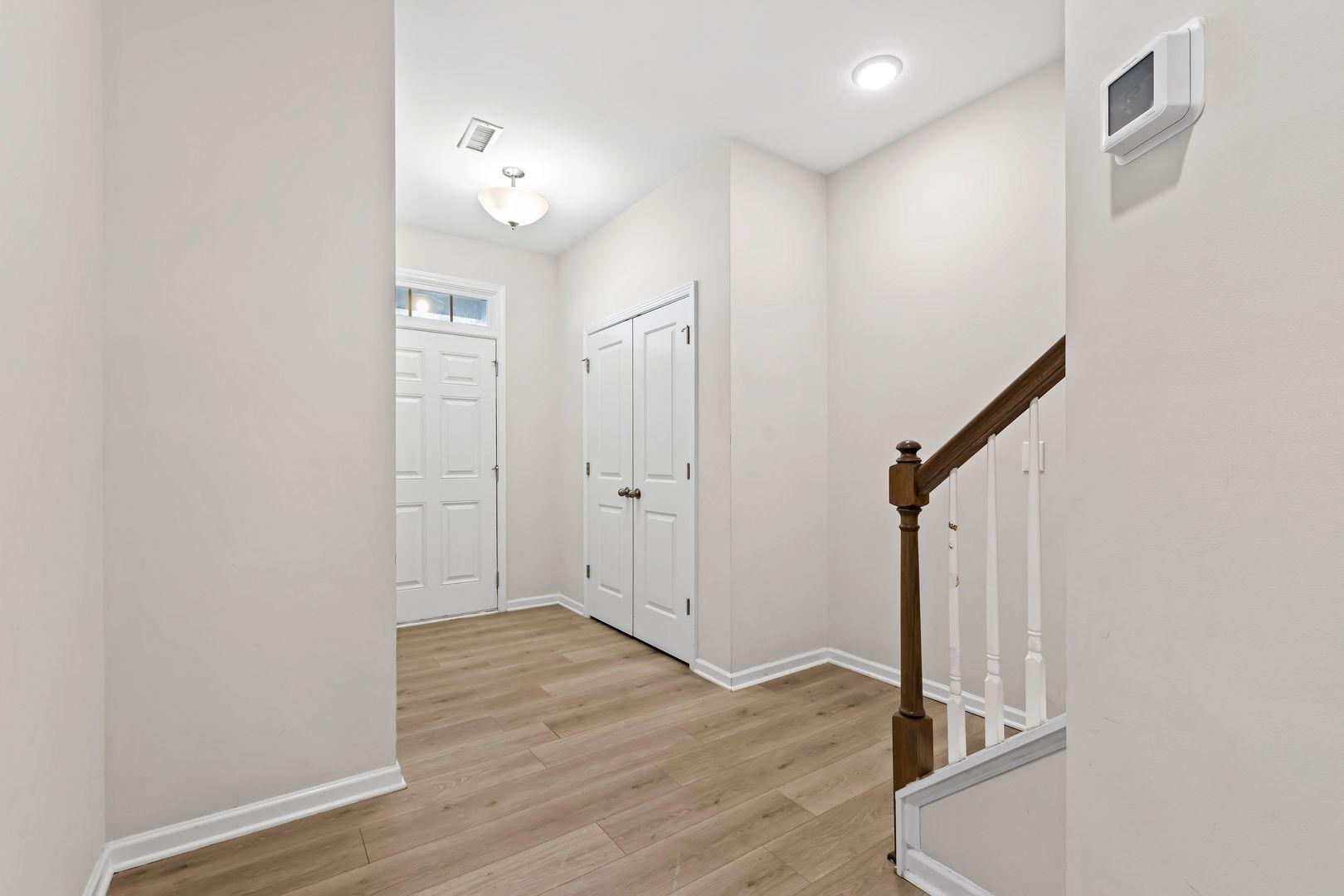 6103 Kayton Street Raleigh, NC 27616 - Photo 8 of 45 a view of a hallway with wooden floor and staircase