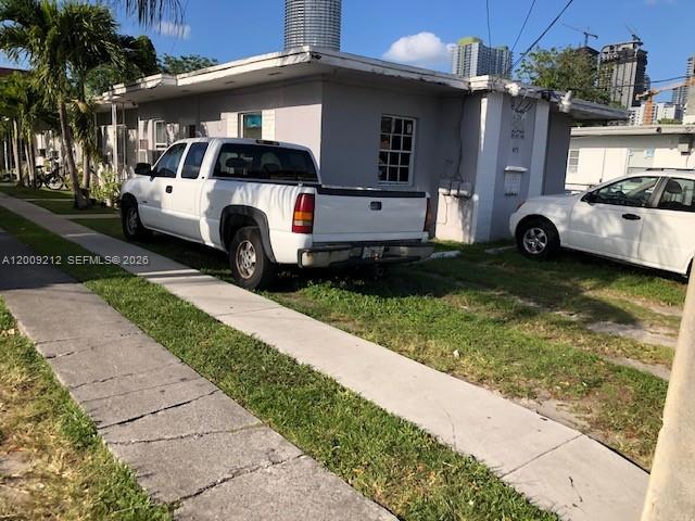 471 Southwest 10th Street, Unit 5 Miami, FL 33130 - Photo 8 of 10 a front view of a house with a garden and parking space