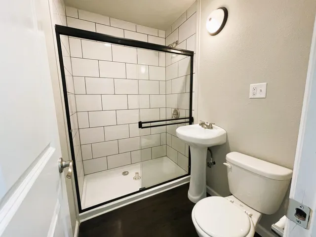 a bathroom with a sink toilet and shower
