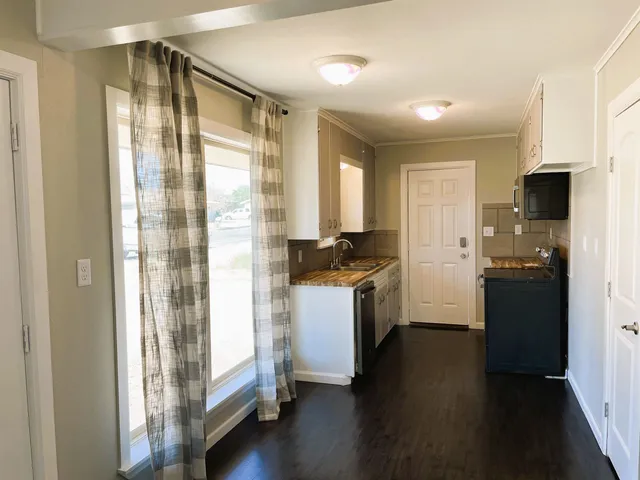 a kitchen with a refrigerator and a sink