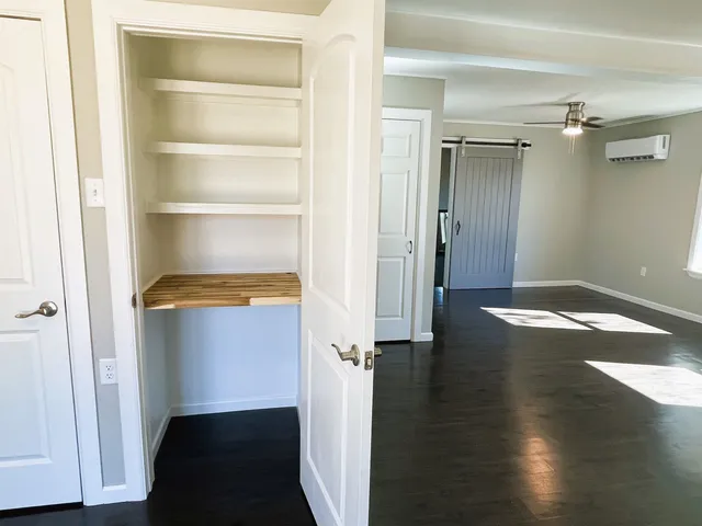 a view of a room with wooden floor