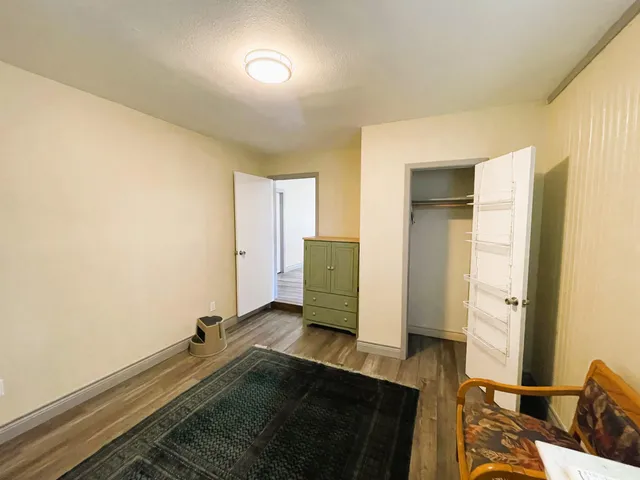 a view of an empty room and wooden floor