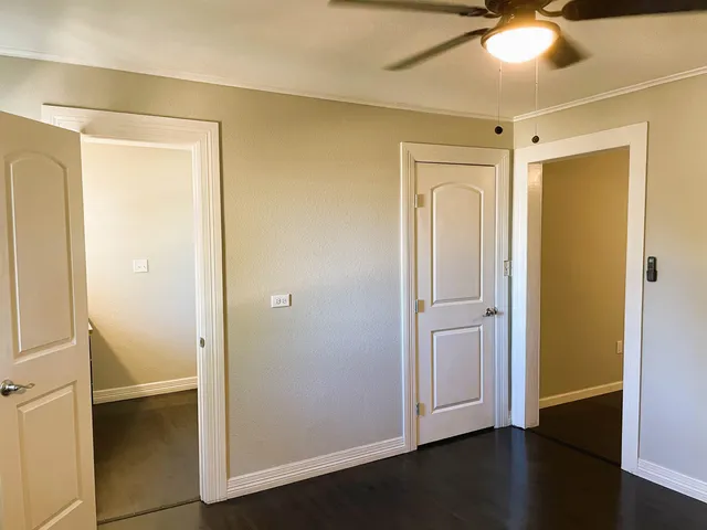 a view of empty room with wooden floor
