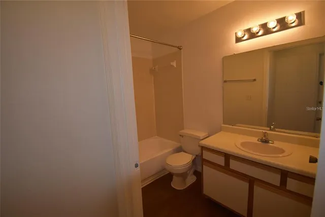 a white toilet sitting next to a bath tub