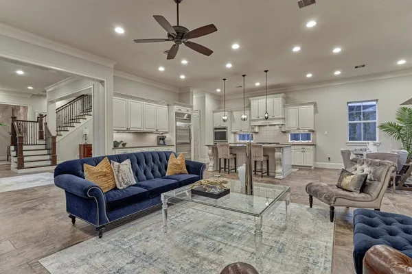 a kitchen with kitchen island granite countertop a sink cabinets and stainless steel appliances