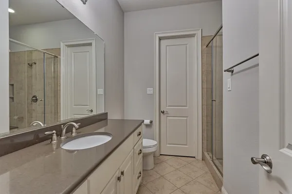 a bedroom with a bed and a potted plant