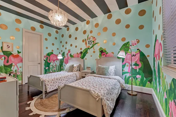 a bedroom with furniture and a large window