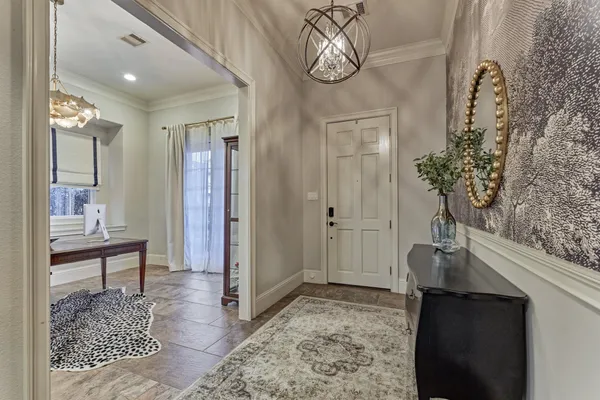 a view of a dining room with furniture and chandelier
