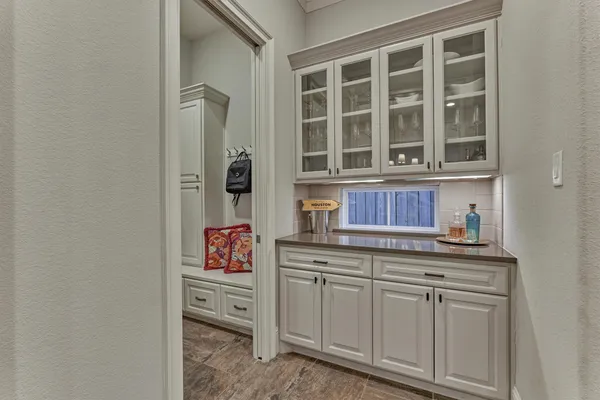 a living room with furniture a fireplace and a kitchen view