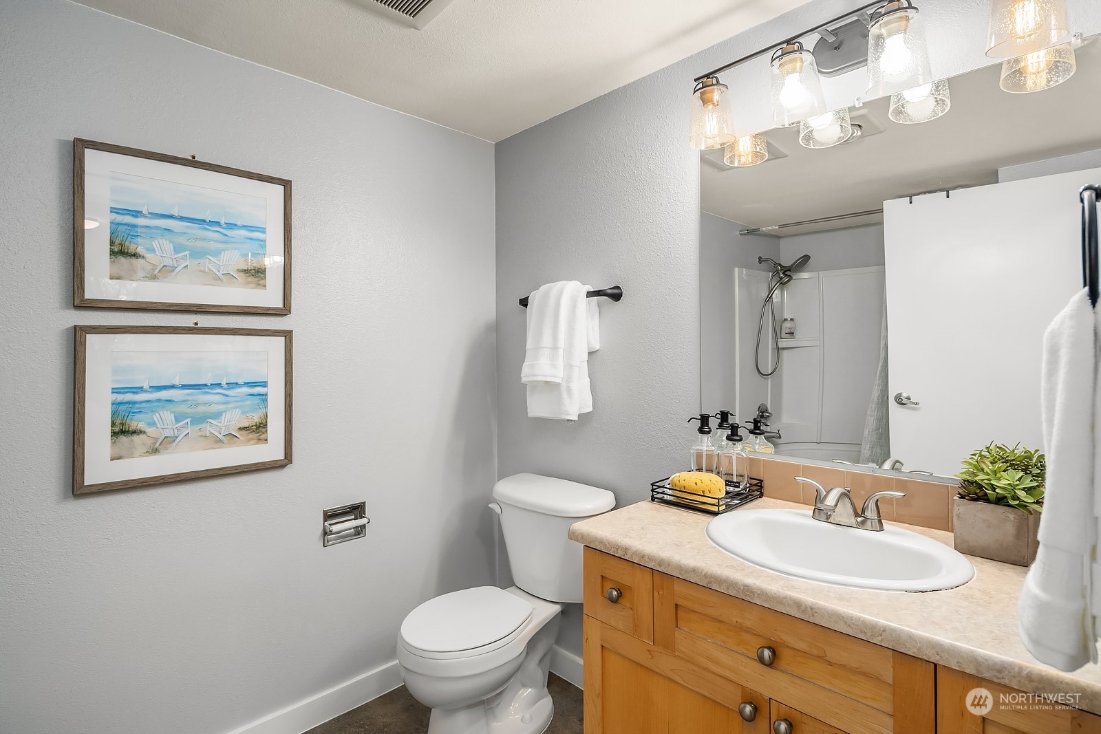 9805 Avondale Road Northeast, Unit R149 Redmond, WA 98052 - Photo 17 of 21 a bathroom with a toilet a sink and mirror