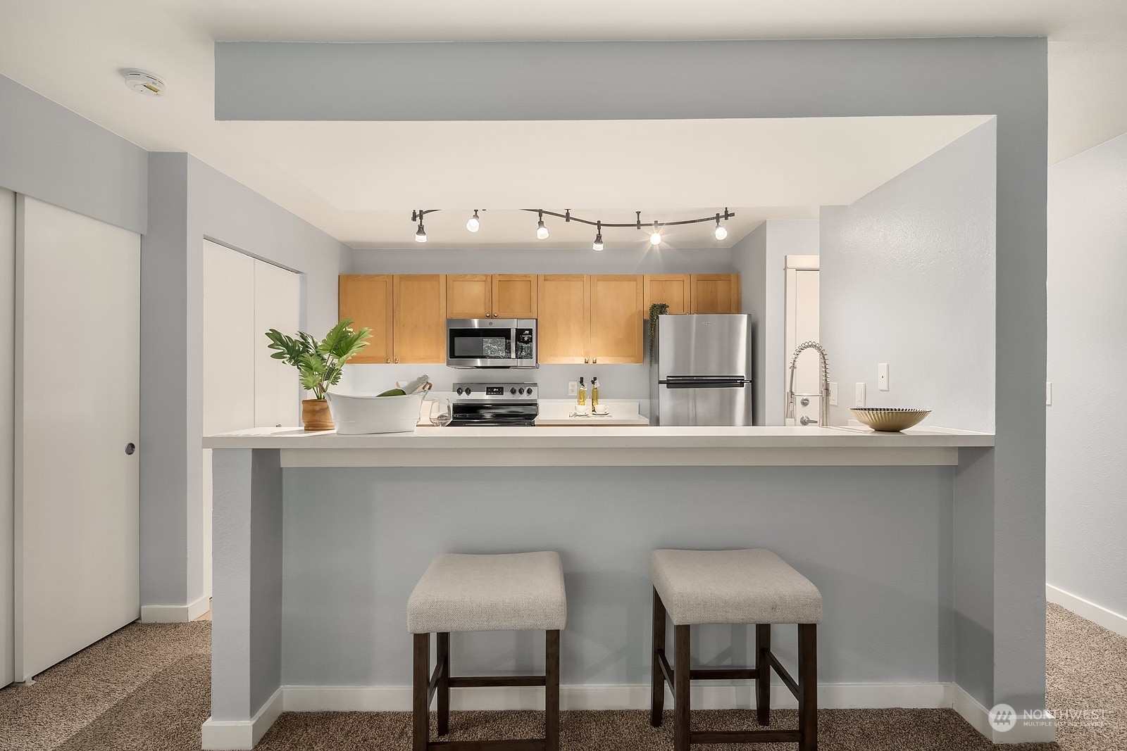 9805 Avondale Road Northeast, Unit R149 Redmond, WA 98052 - Photo 5 of 21 a kitchen with stainless steel appliances a sink and cabinets