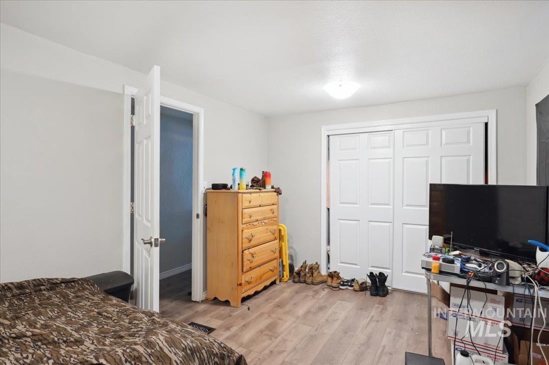 790 North Riviera Drive Boise, ID 83703 - Photo 11 of 15 Bedroom with light wood-type flooring and a closet