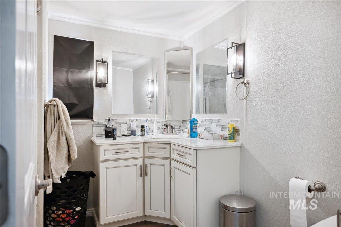 790 North Riviera Drive Boise, ID 83703 - Photo 14 of 15 Bathroom with crown molding, vanity, and decorative backsplash