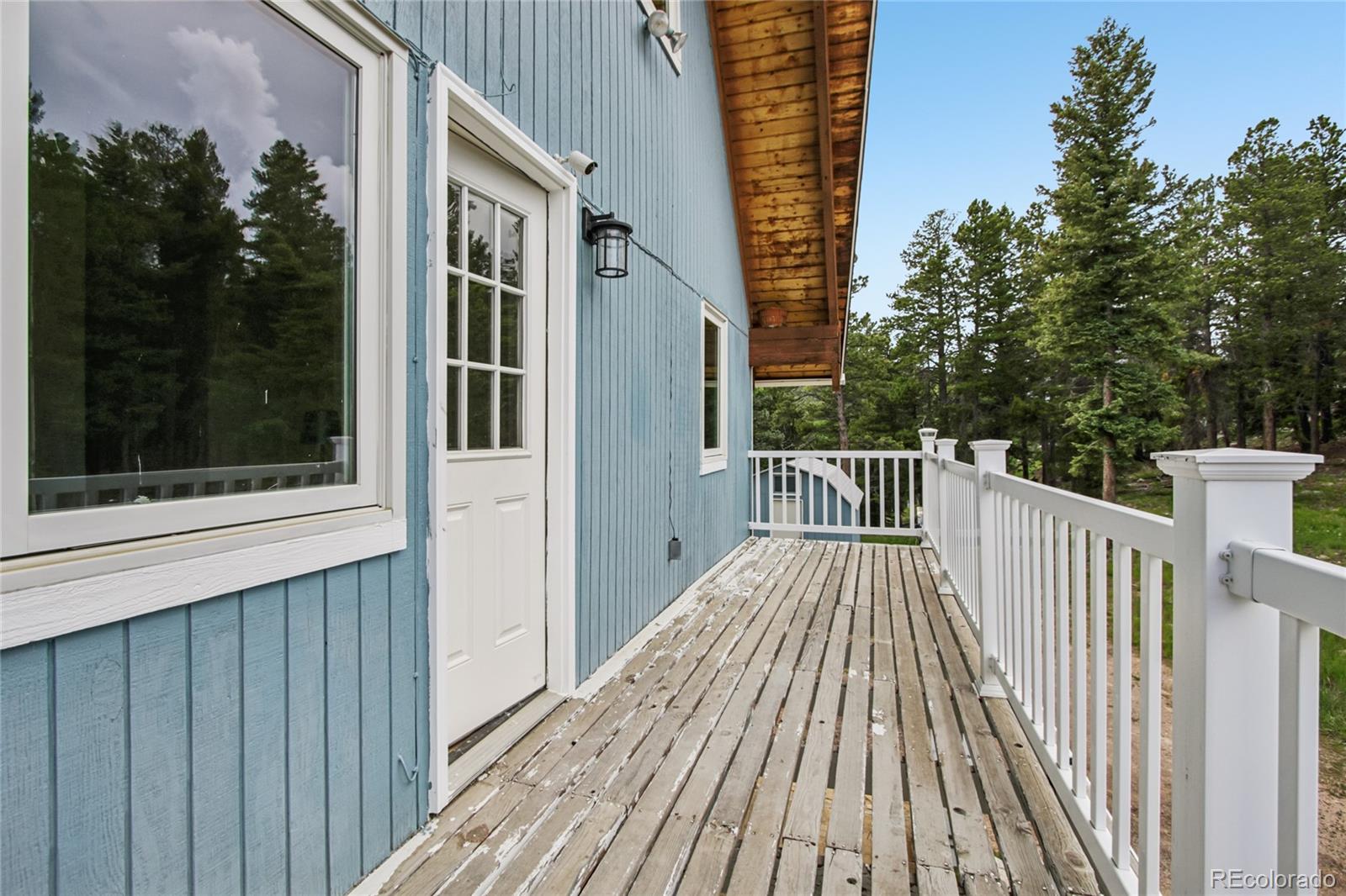 1472 Sinton Road Evergreen, CO 80439 - Photo 33 of 39 a view of a wooden deck and a yard with wooden fence