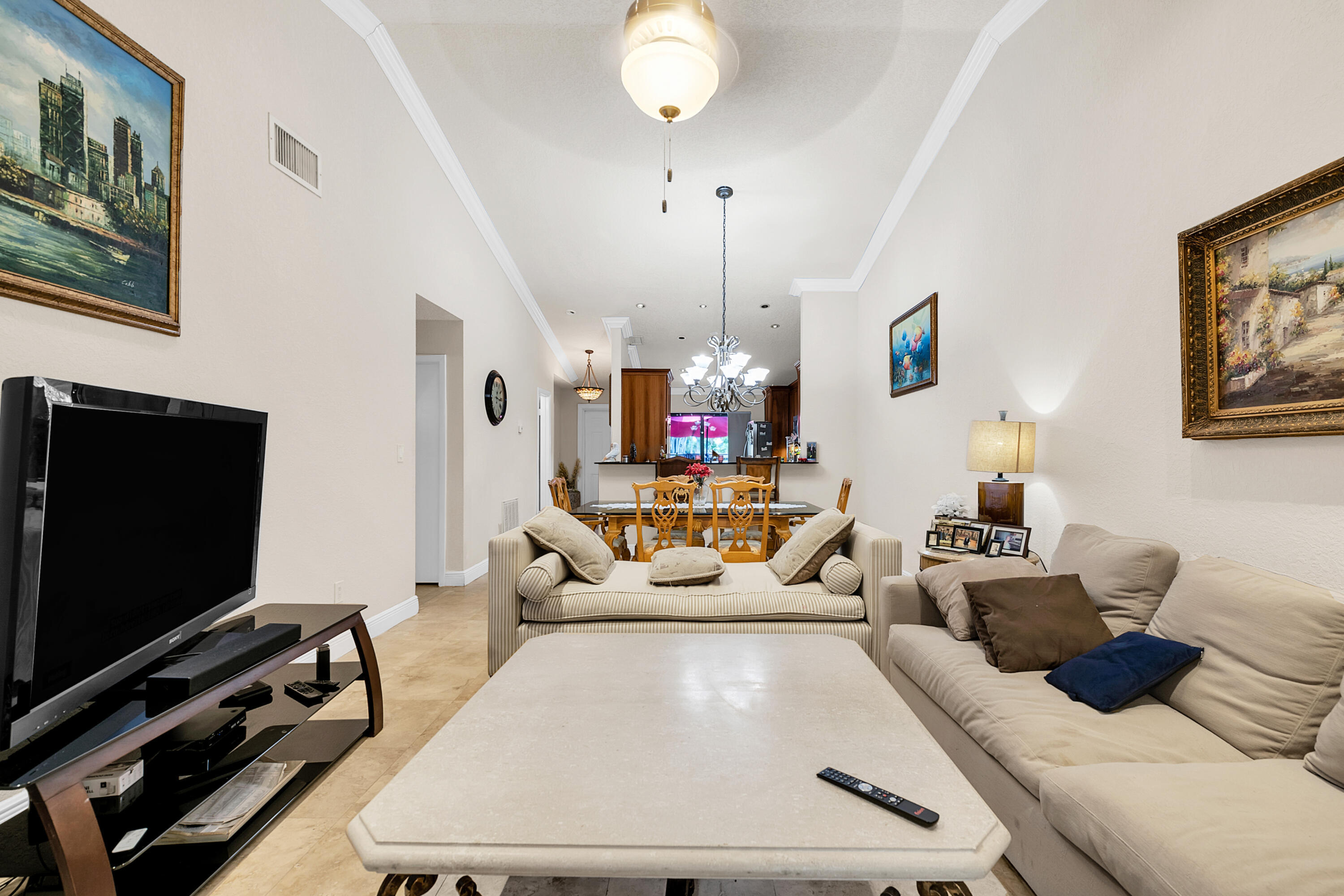 8440 Boca Glades Boulevard East Boca Raton, FL 33434 - Photo 6 of 16 a living room with furniture and a flat screen tv