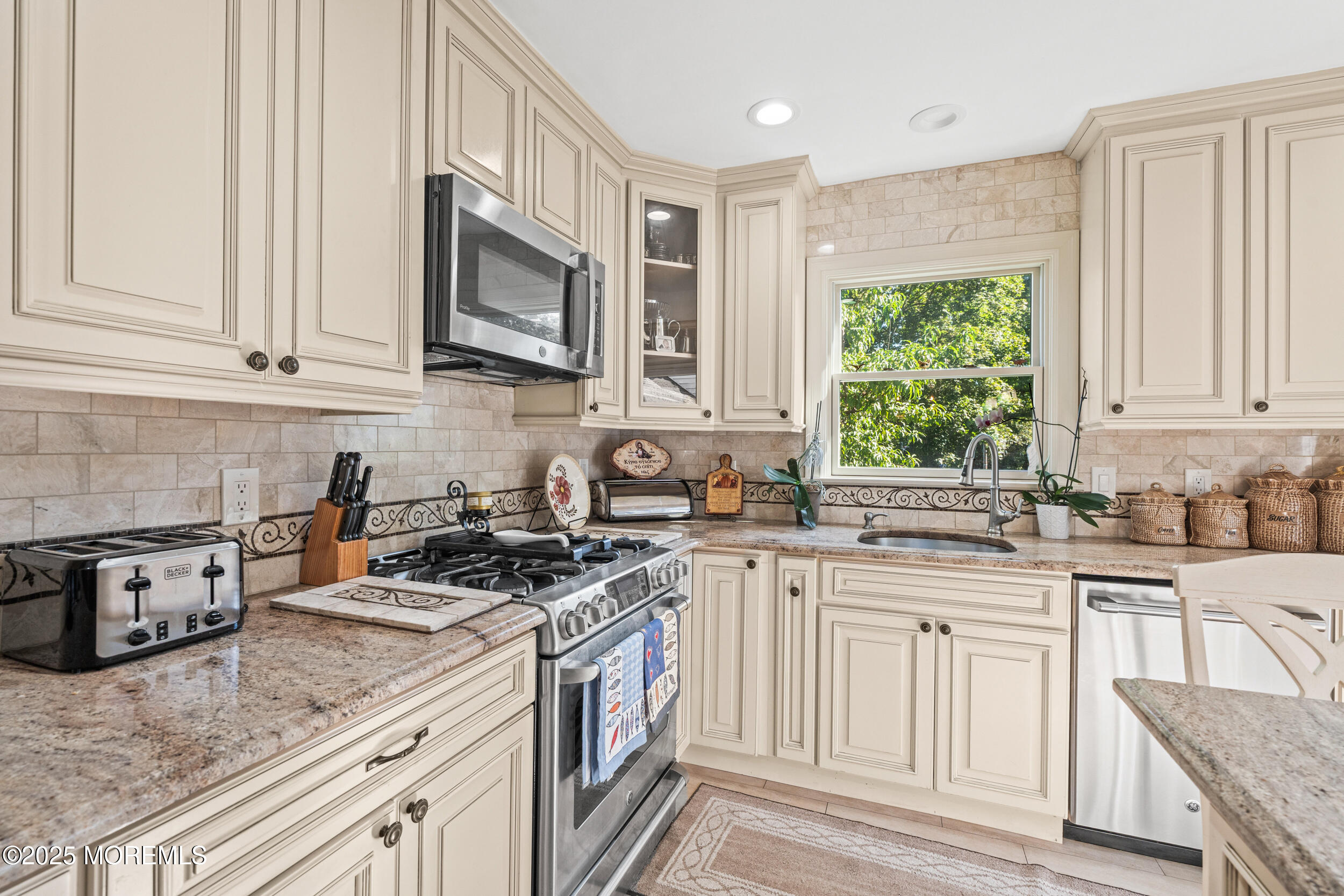 514 Deal Road Asbury Park, NJ 07712 - Photo 14 of 36 a kitchen with stainless steel appliances granite countertop a stove a sink and a microwave