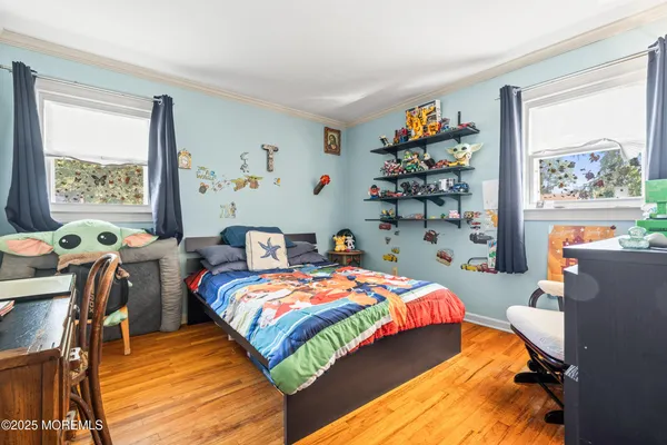 a bedroom with bed and flat screen tv