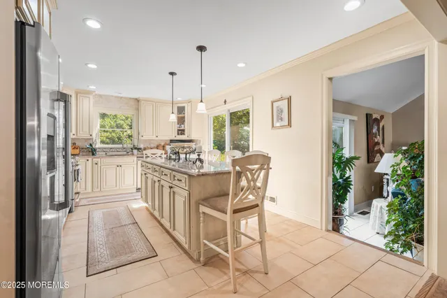 a kitchen with center island table and chairs