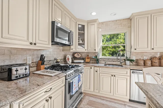 a bathroom with a sink and mirror with toilet