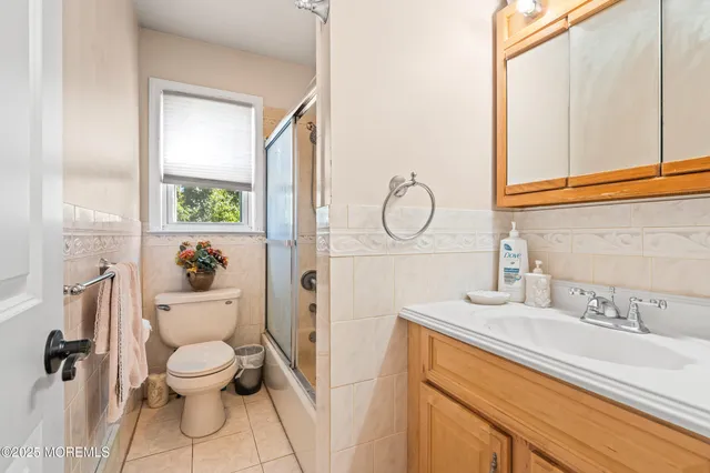 a spacious bedroom with a bed and a flat screen tv