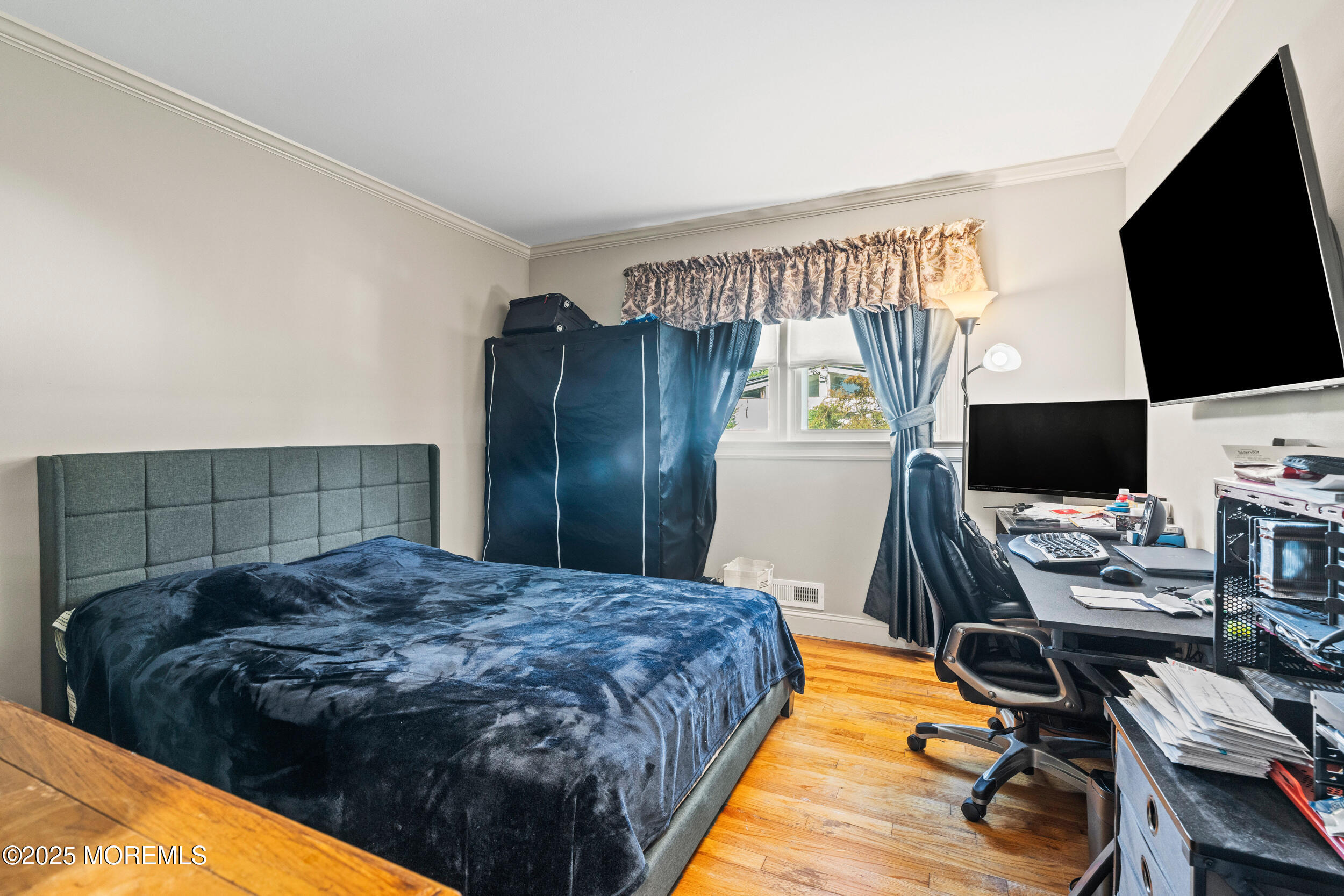 514 Deal Road Asbury Park, NJ 07712 - Photo 25 of 36 a spacious bedroom with a bed and a flat screen tv