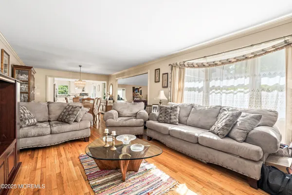 a kitchen with stainless steel appliances granite countertop a refrigerator a sink a stove and white cabinets