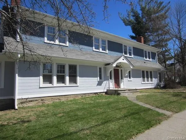 a front view of a house with a garden