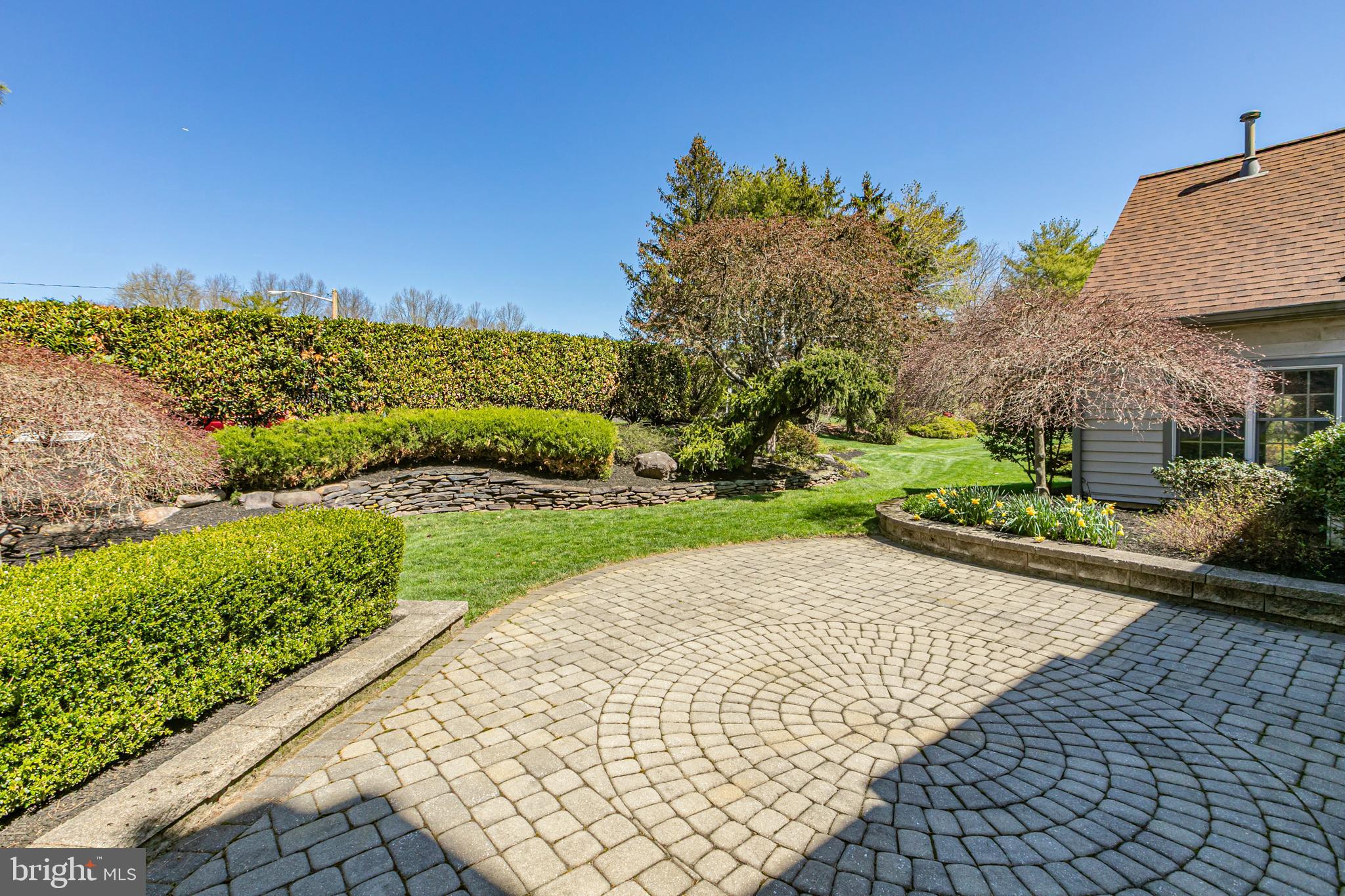 30 Baldwin Street Pennington, NJ 08534 - Photo 32 of 37 a view of a garden with an empty space and a house in the background