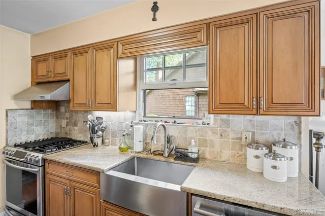 a living room with furniture a fireplace and a chandelier