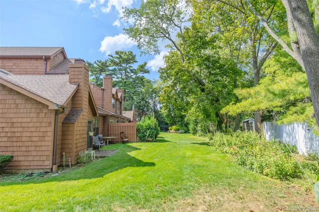 a view of a hallway to a livingroom with furniture