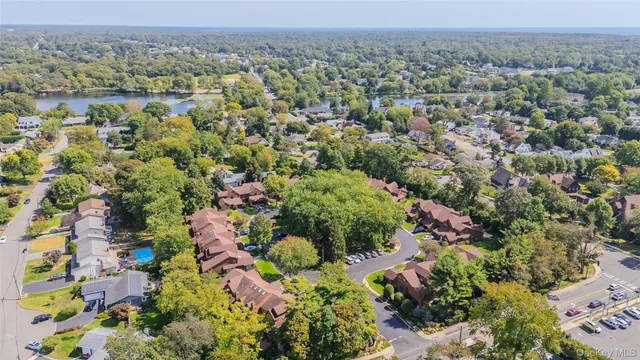 an aerial view of a house with yard and swimming pool
