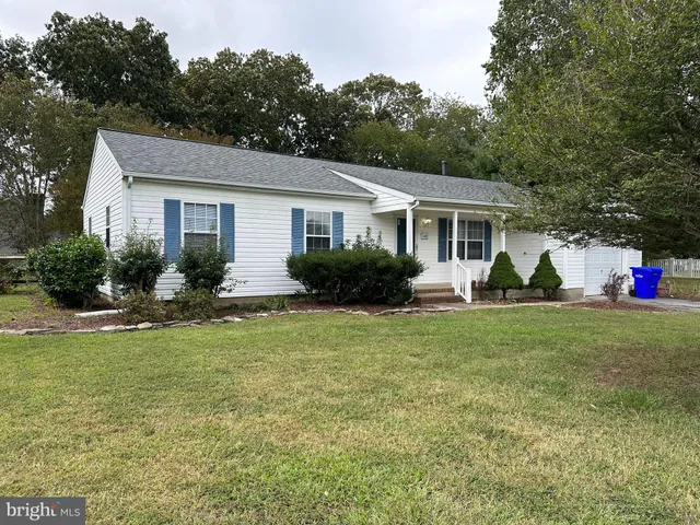 a view of a house with a backyard and a patio
