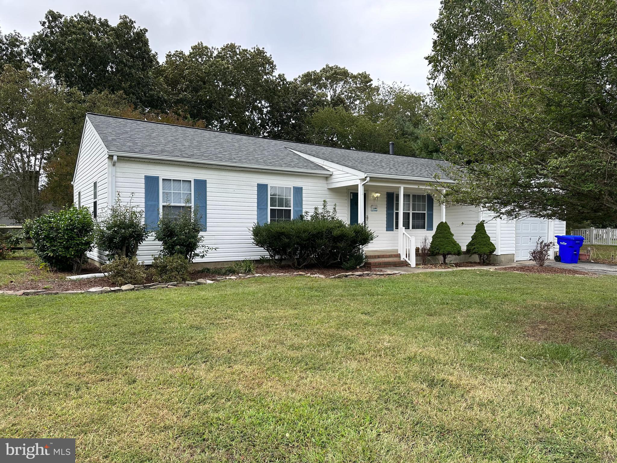 a view of a house with a backyard and a patio