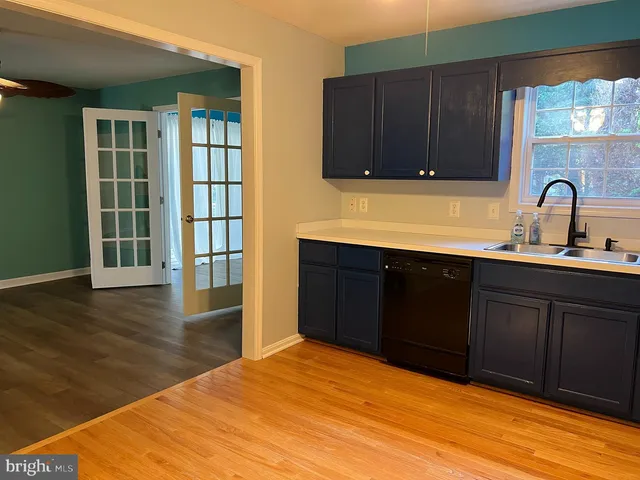 a kitchen with stainless steel appliances granite countertop a stove and a wooden cabinets