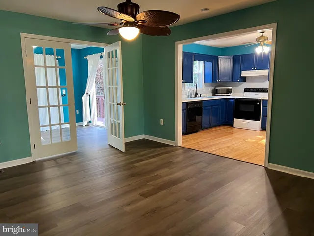 a view of a kitchen with a sink and a refrigerator