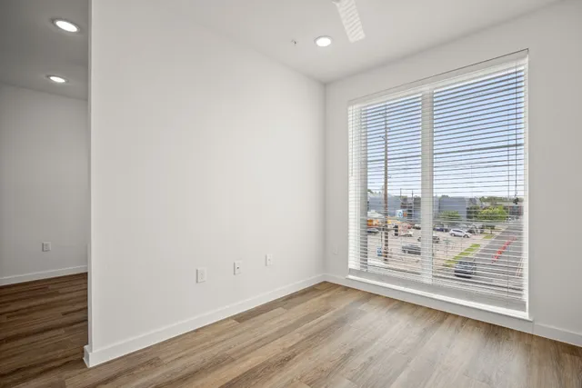 a view of wooden floor and windows in a room