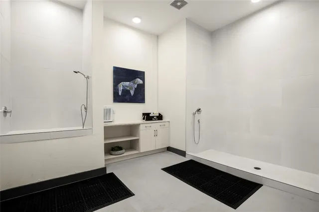 a room with a white wall and a stove