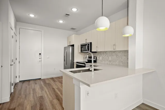 a kitchen with cabinets and stainless steel appliances