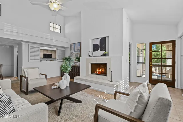 a living room with furniture a table and a fireplace