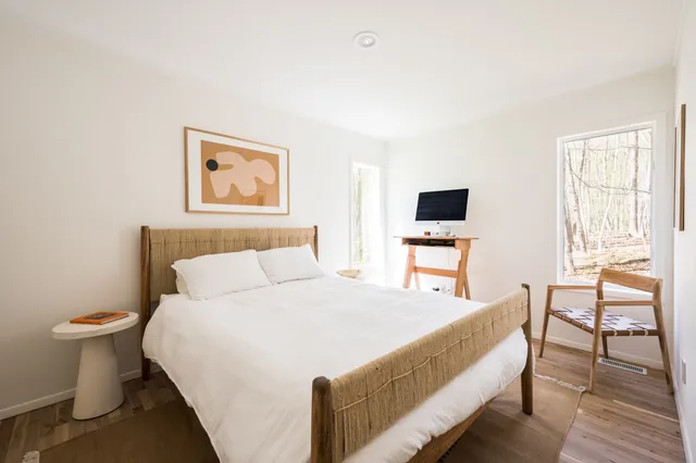 a bed room with a bed and a chair