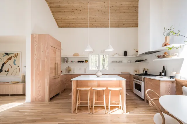 a kitchen with a table chairs stove and cabinets