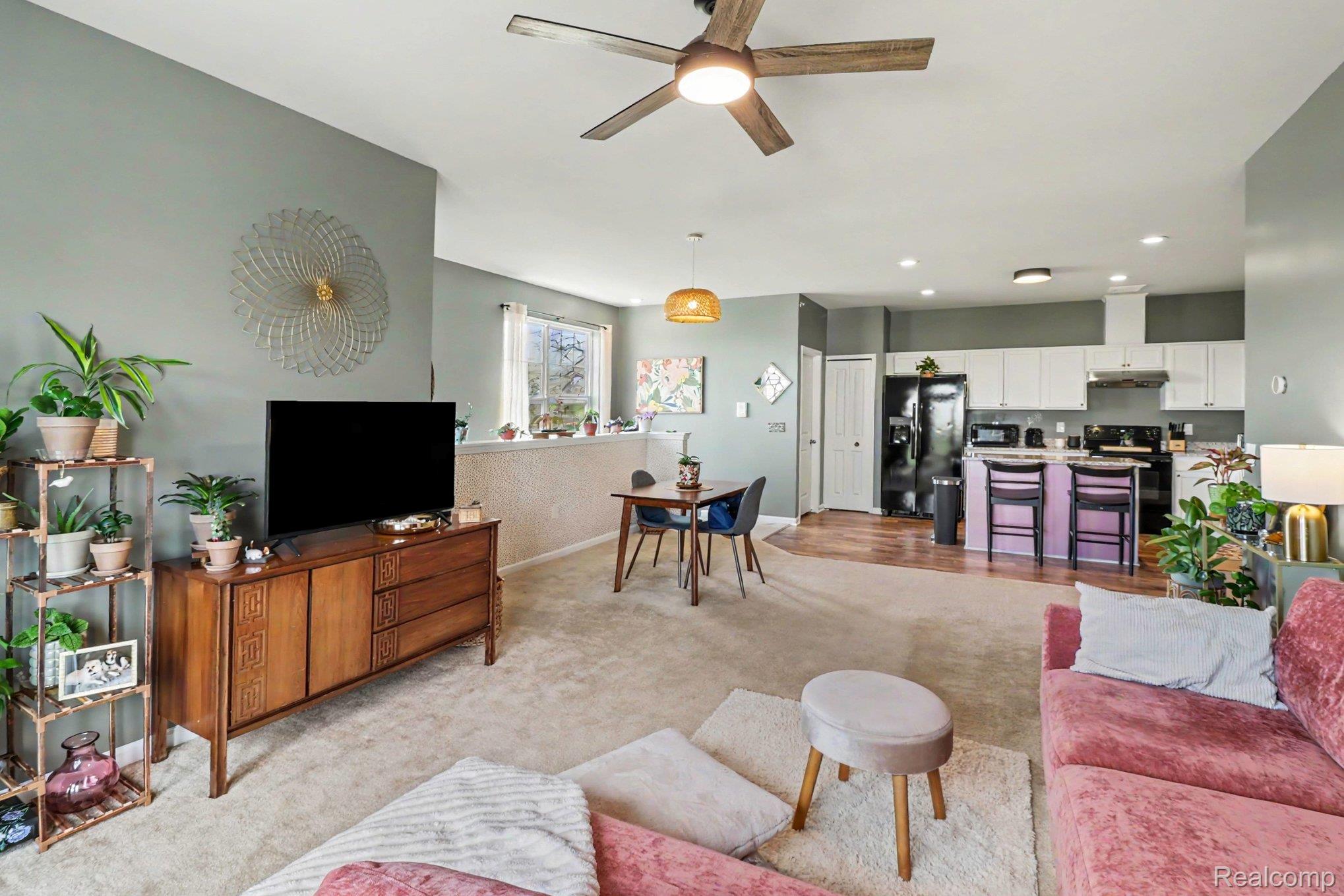 9864 Ridge Run Street Howell, MI 48855 - Photo 5 of 23 Living room with a ceiling fan and light colored carpet