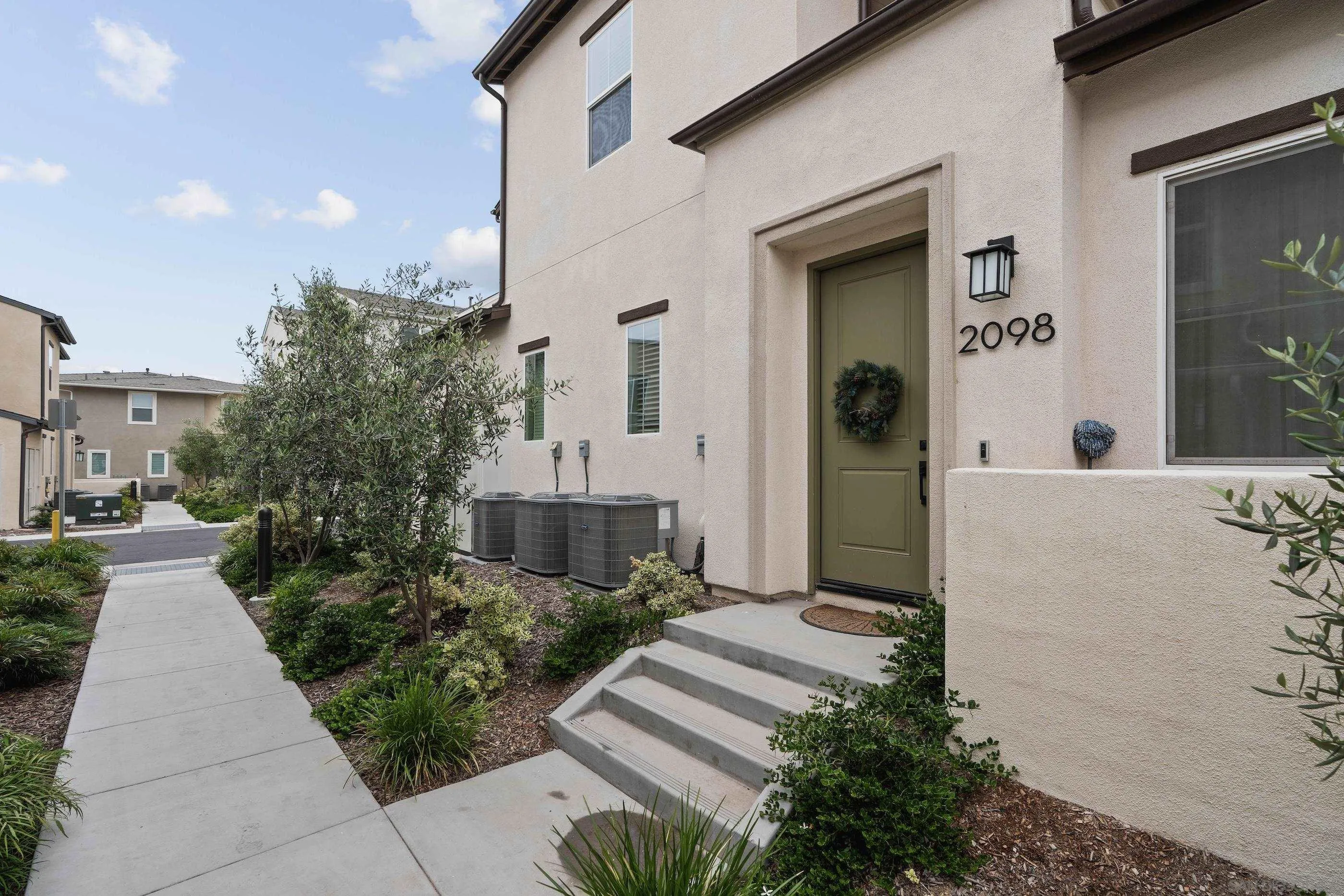 2098 Bluestone Circle Chula Vista, CA 91913 - Photo 2 of 25 a front view of a house with garden