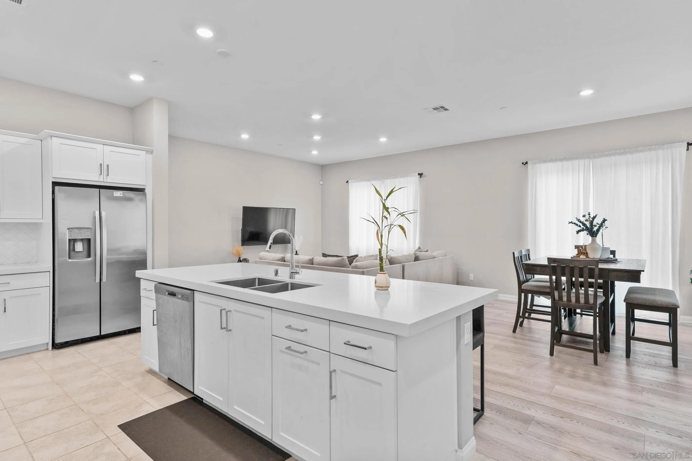 2098 Bluestone Circle Chula Vista, CA 91913 - Photo 9 of 25 a kitchen with a sink and chairs
