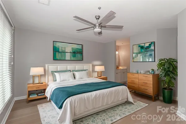 a bedroom with a bed and a chandelier