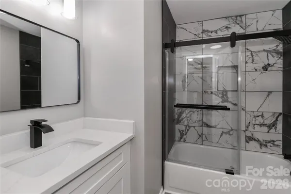 a bathroom with a bathtub and a sink