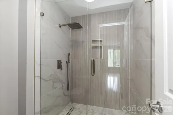 a bathroom with a glass shower door
