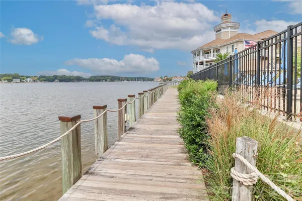 a view of a pathway of a house with wooden bridge