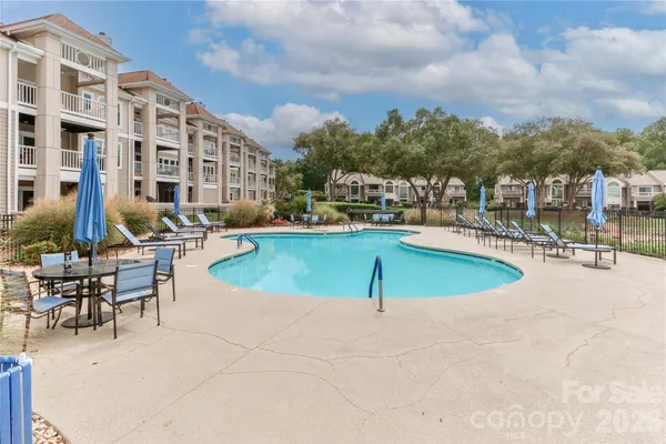 a view of a swimming pool with outdoor seating